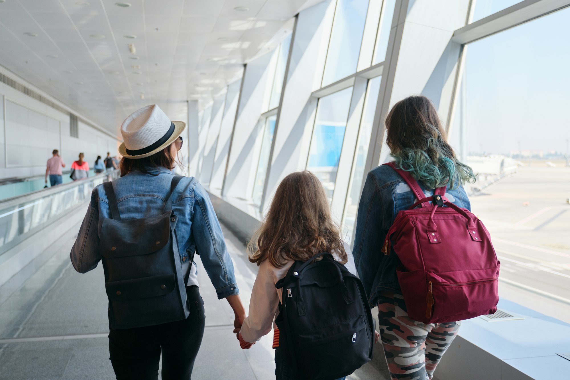 Airport terminal inside, walking people passengers with luggage